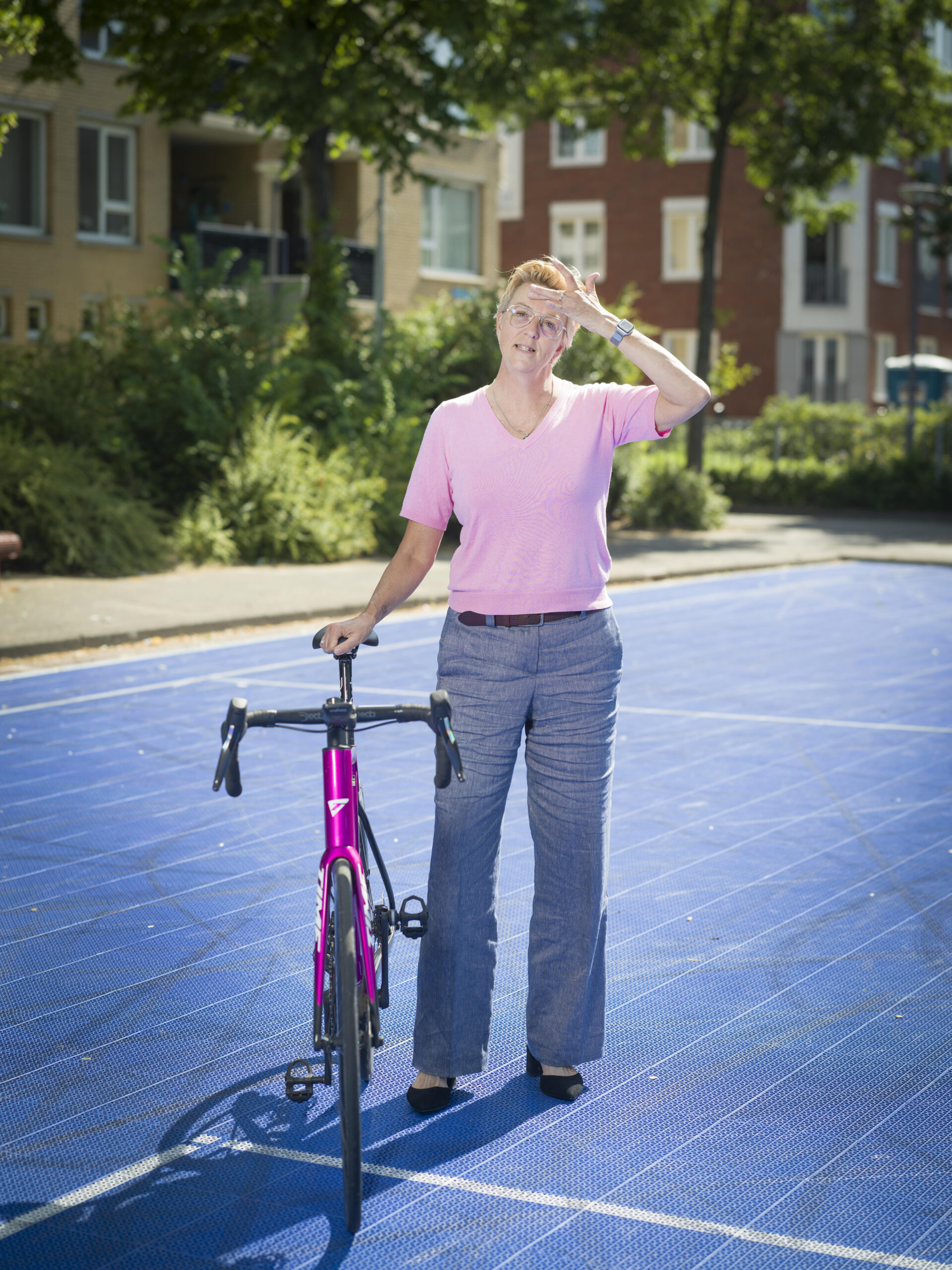 sportfilosoof Sandra Meeuwsen met een wielrenfiets op het sportveld